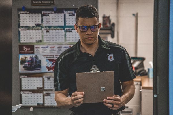 A man checking his writepad for packaging quotation