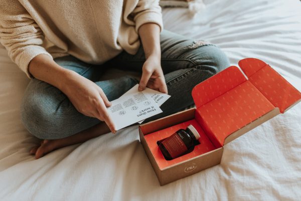 Person unboxing health care brand packaging